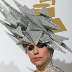Lady Gaga poses with her awards during t