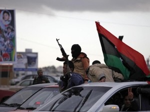 Libyan gunman celebrate on the early morning of the second anniversary of the revolution that ousted Moammar Gadhafi, in Benghazi, Libya, Sunday, Feb. 17, 2013. (AP Photo/Mohammad Hannon)