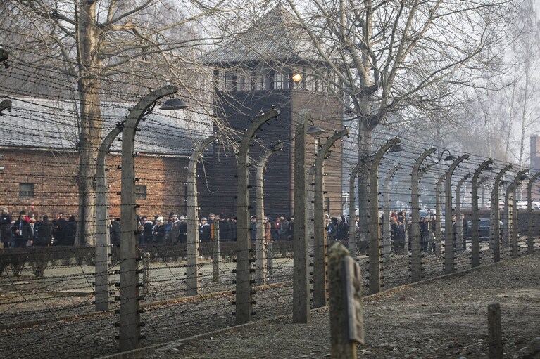 People arrive for commemorations at the Auschwitz Nazi death camp in Oswiecim, Poland, Monday, Jan. 27, 2020. Survivors of the Auschwitz-Birkenau death camp gathered for commemorations marking the 75th anniversary of the Soviet army's liberation of the camp, using the testimony of survivors to warn about the signs of rising anti-Semitism and hatred in the world today.(AP Photo/Czarek Sokolowski)