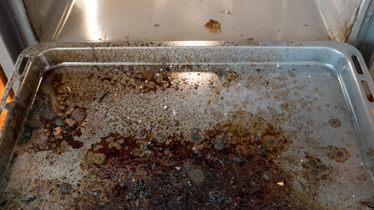 Here's Why Sheet Pans Pop In The Oven And How You Can Prevent It