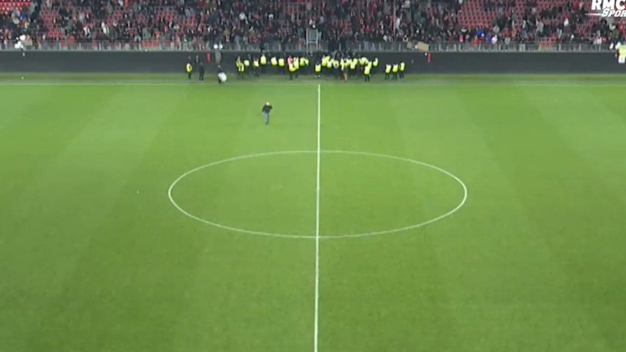 Il terreno di gioco vuoto, con i tifosi a bordo campo che si scontrano con il cordone degli steward