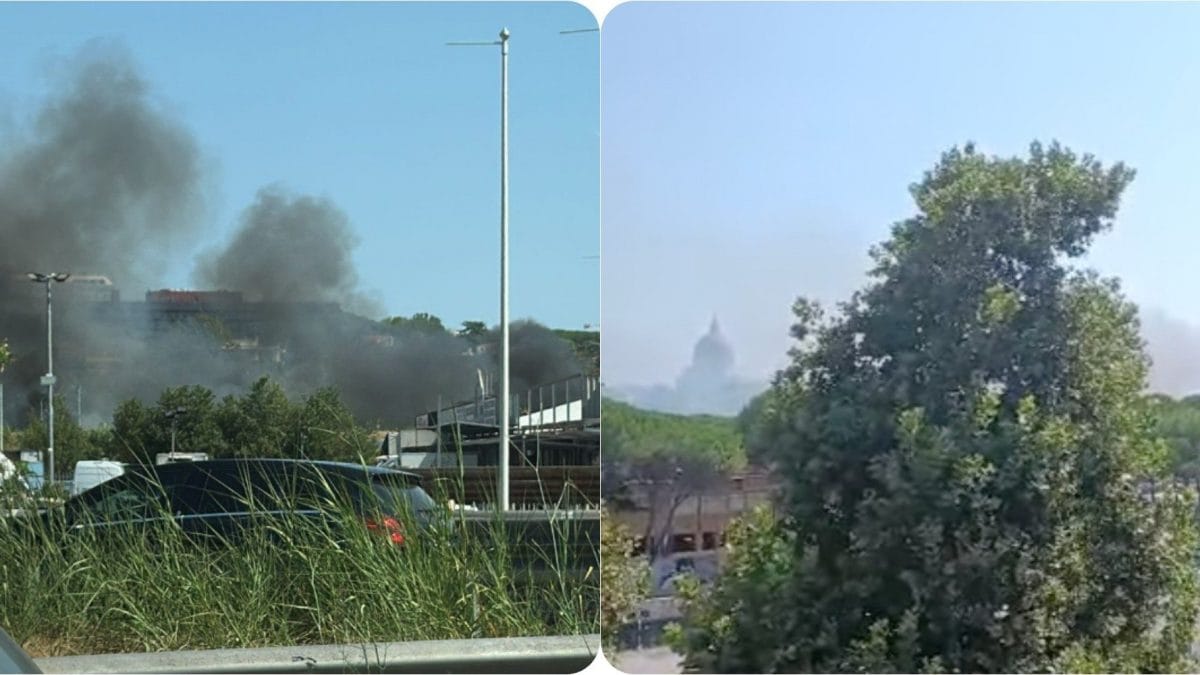 Incendio Magliana, foto da Facebook. A destra, sullo sfondo, la sagoma della basilica dei santi Pietro e Paolo.