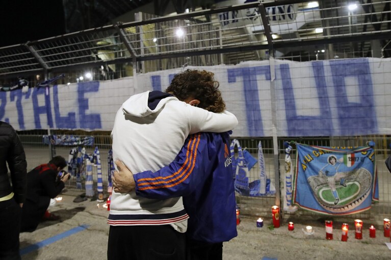 Un abbraccio davanti allo Stadio San Paolo di Napoli durante la veglia per Maradona.