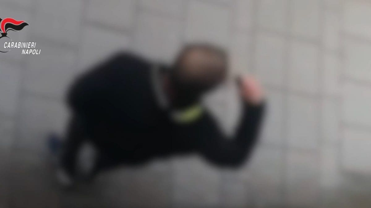 L’uomo mentre mima il gesto di sgozzare verso la ex compagna