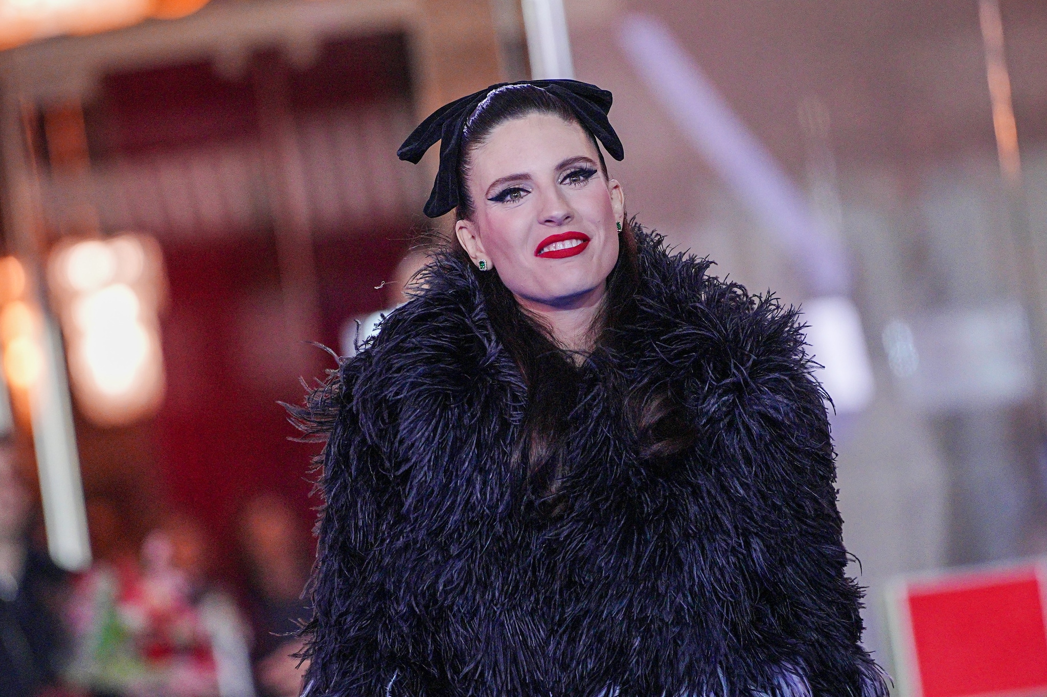 Col fiocco tra i capelli durante la sfilata sul red carpet