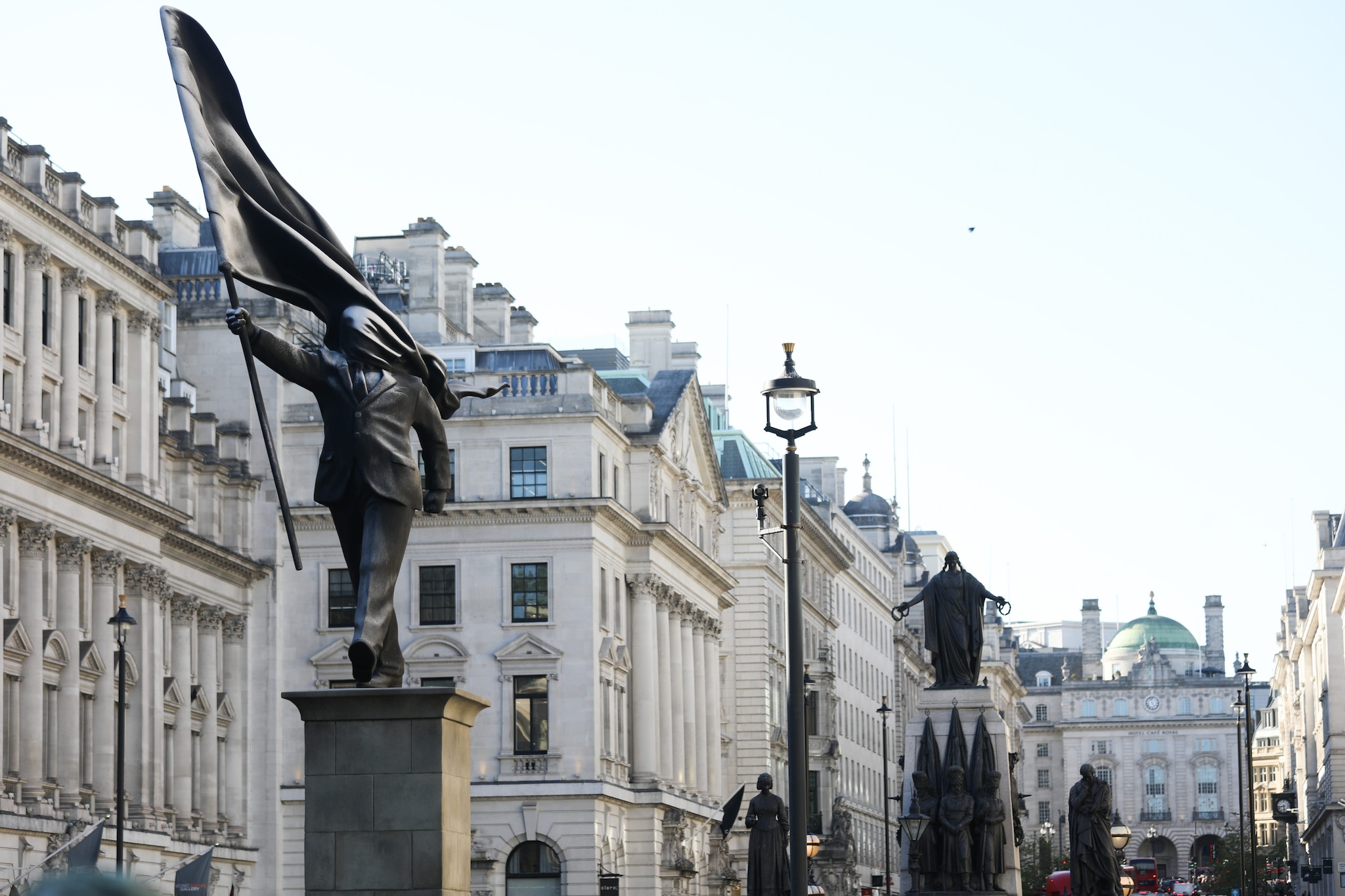 La scultura di Banksy, situata vicino a quella di altre figure storiche dell’Imperialismo britannico