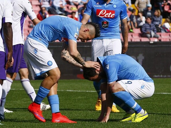 Napoli’s forward from Argentina Gonzalo Higuain (R) is comforted by teammate Napoli’s forward from Slovakia Marek Hamsik during the Italian Serie A football match SSC Napoli vs Fiorentina ACF on April 12, 2015 at the San Paolo stadium in Naples. AFP PHOTO / CARLO HERMANN (Photo credit should read CARLO HERMANN/AFP/Getty Images)